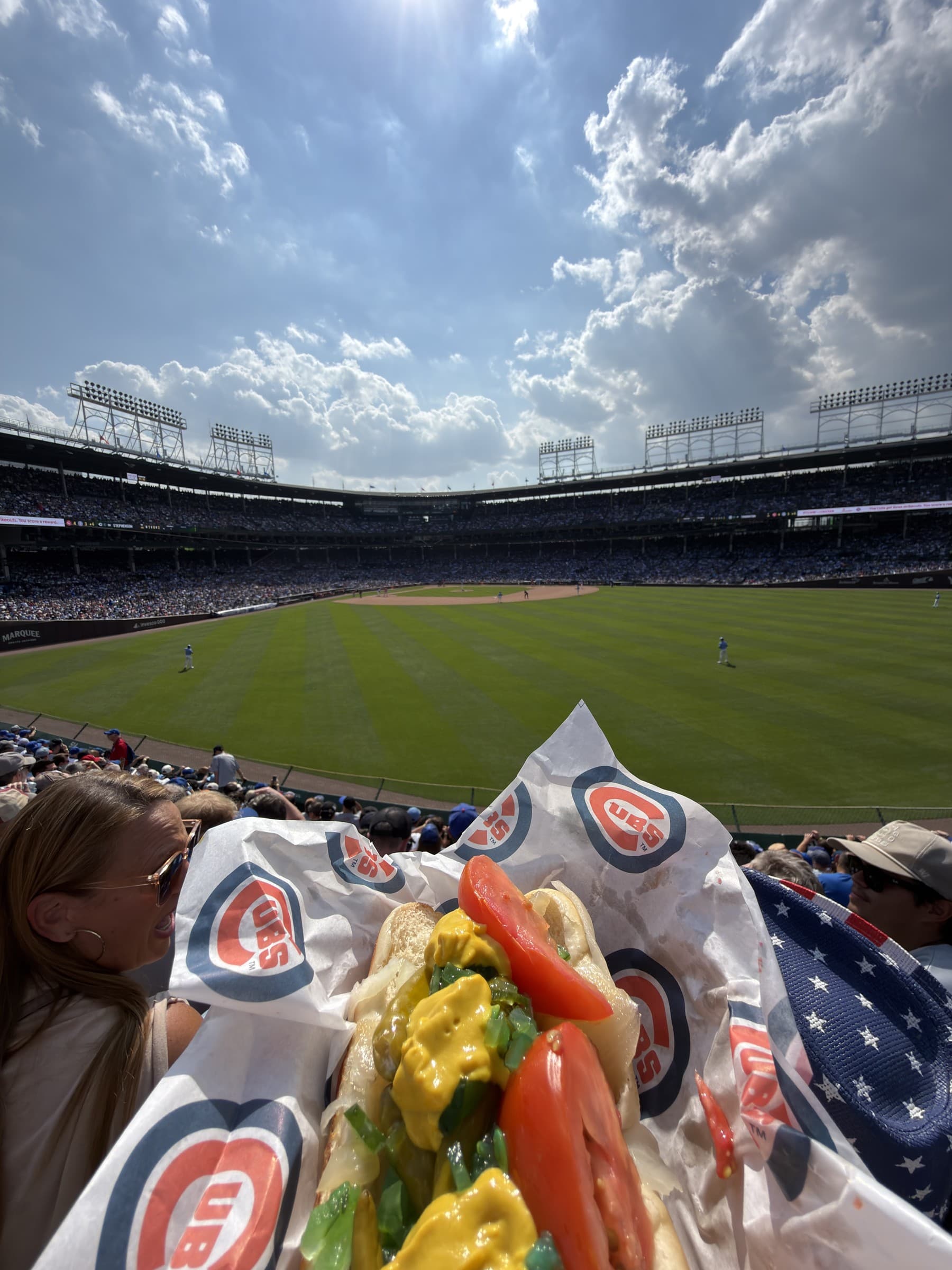 A hot dog in the foreground and Wrigley Field beyond it, photographed August 28, 2026.