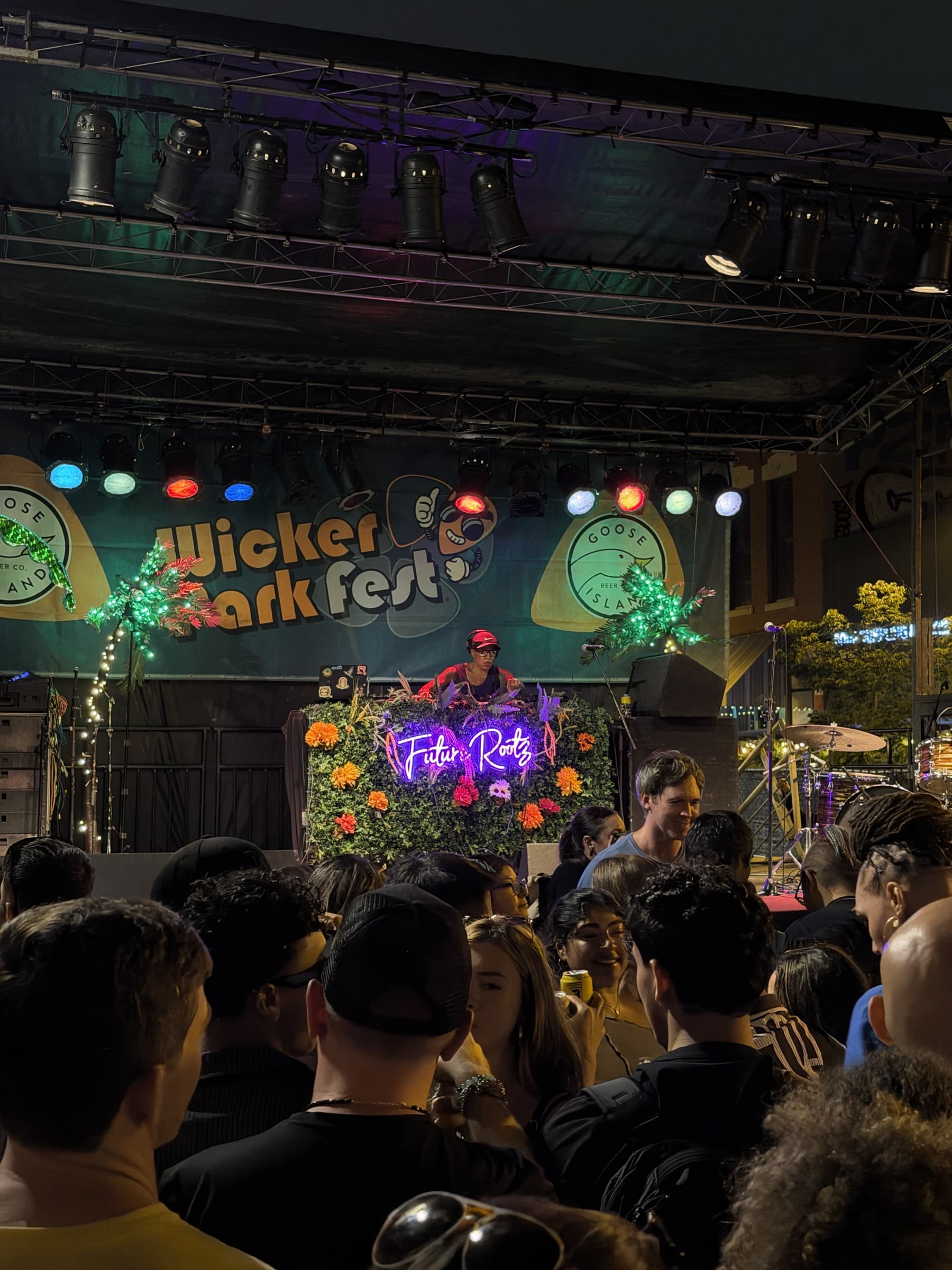 A flower-covered booth with Future Rootz signage at Wicker Park Fest on July 25, 2026. The performer is not identified.